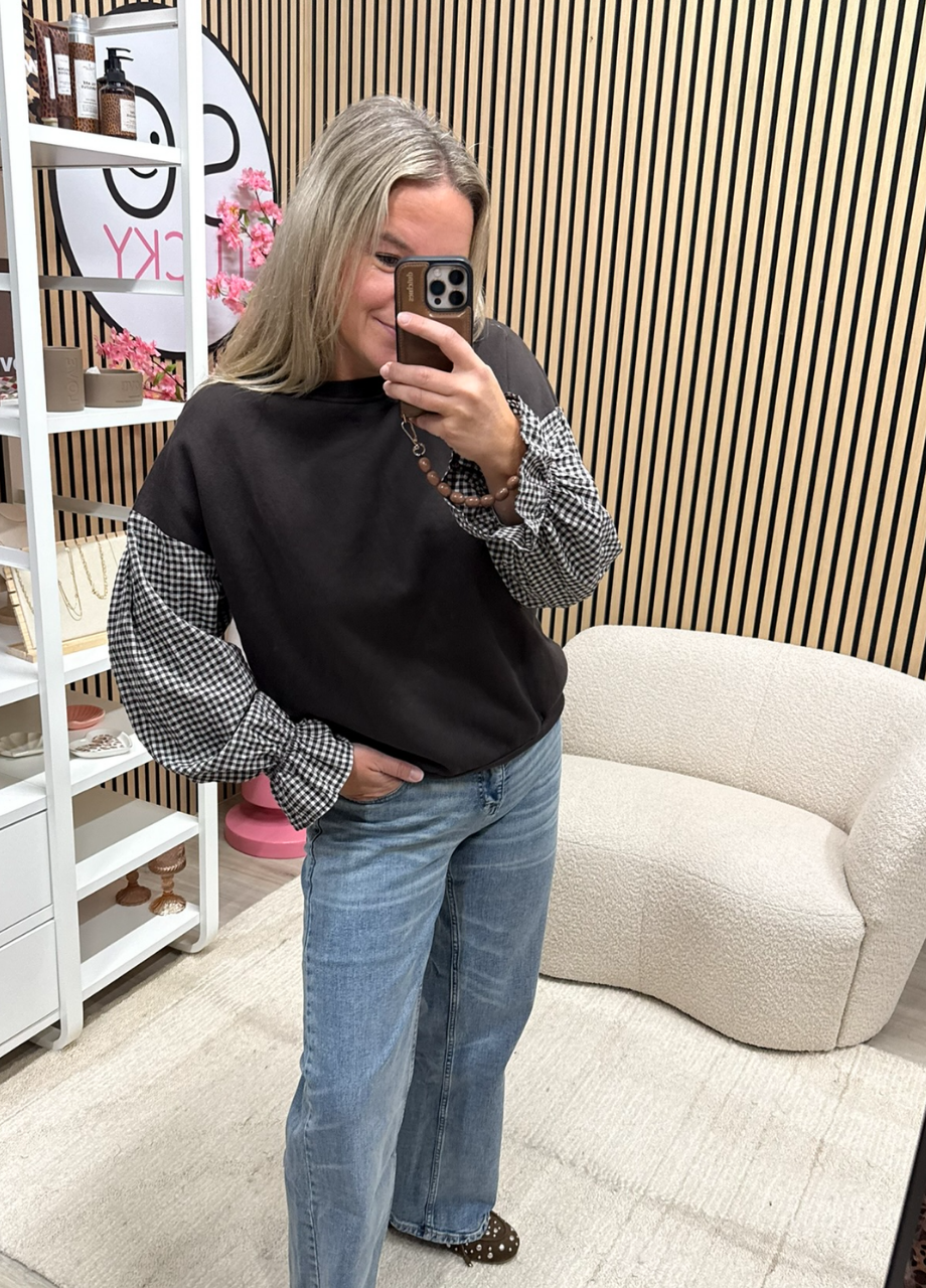 bruine sweater met ruitjesmouwen Model draagt bruine sweater met bruin witte ruitjesmouwen op jeans - So Lucky